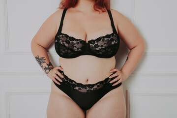 body acceptance concept. curvy girl posing in studio against society prejudice