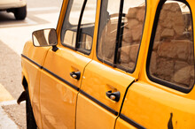 Close-up Of Old Yellow Car On Street
