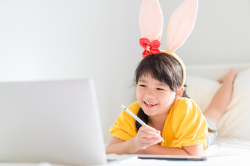 Sticker - Asian girl student online learning.study online video call.Smart kid girl learn english online with laptop home.Online Easter holidays lockdown.Child girl.Covid19 coronavirus.Social distance.easter.