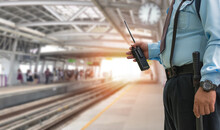 Professional Security Guard Hand Holding Cb Walkie-talkie Radio In Electric Train Station, Copy Space For Text.