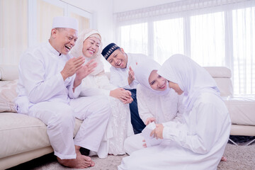 Wall Mural - Muslim little girl opening envelope from her family