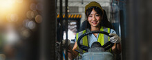Asian Beautiful Woman Driver Drive Fork  Lift Car In Industry With Smiled, Ability Of Girl And Diversity Of Career Wearing Helmet In  Reflective Vest Working On Vehicle
