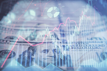  Double exposure of forex graph drawing over us dollars bill background. Concept of financial markets.