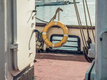 A Yellow Lifebelt, Lifebuoy, Water Wheely Also Known As Kisbee Ring On A An Old Boat.