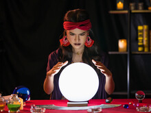 Asian Fortune Teller Looking At Crystal Ball