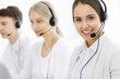 © Iryna - Call center. Group of diverse operators at work. Beautiful woman in headset communicating with customers of telemarketing service. Business concept