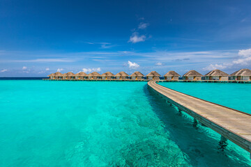 Canvas Print - Ocean lagoon bay view, blue sky and clouds with wooden jetty and over water bungalows, villas, endless horizon. Meditation relaxation tropical background, sea ocean water. Skyscape seascape background