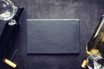 Wall Mural - A glass of red dry wine on the table. Dark bottle and glass of wine.