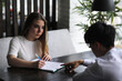 © alexkich - A pair of young people talking at the office