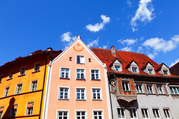 Wall Mural - Colorful tenement houses with attics . Facade with Sundial . European residential district 