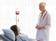 © Bangkok Click Studio - The senior elder female doctor visits the ward and talks to a patient on a bed for diagnosis and curing.