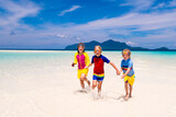Fototapeta  - Kids playing on beach. Children play at sea.