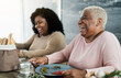 © Alessandro Biascioli - Happy black mother and daughter having fun eating healthy lunch at home