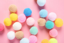 Closeup Shot Of Colorful Soft Pom Pom Balls On Pink Background