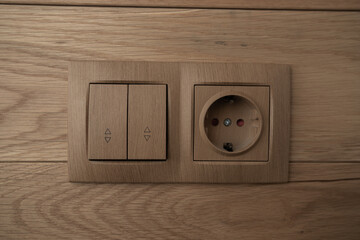 Electric light switch and socket on the empty wall, electrical power socket and plug switched