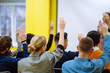 © maxbelchenko - Business people raising hand up to ask question with speaker, to agree or vote for comments in seminar conference. Business group meeting seminar training concept.