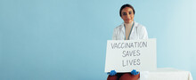 Healthcare Worker With "Vaccination Saves Lives" Banner