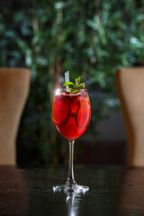 Red coctail with mint n wooden table