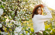 © maxbelchenko - Beautiful young woman near blooming spring tree. Youth, love, fashion, romantic and lifestyle concept.