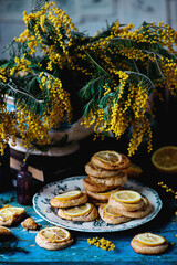 Wall Mural - biscuits with lemon with a bouquet of mimosa.style vintage