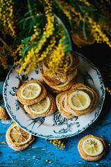 Wall Mural - biscuits with lemon with a bouquet of mimosa.style vintage