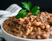 Southern Style Black-Eyed Peas: Closeup View Of A Bowl Of Cooked Cowpeas And Smoked Ham Hocks