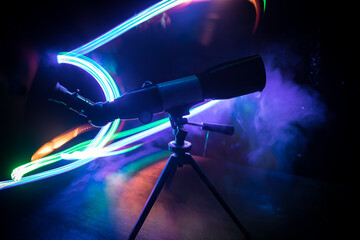 Wall Mural - silhouette of a astronomy telescope on dark foggy backlight.
