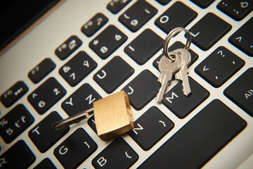 Computer security concept. Unlocked padlock on notebook keyboard. Symbol of safe. Selective focus
