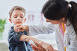 Little boy being vaccinated by pediatrician