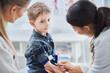 © Kalim - Little boy having blood sample drawn in a lab