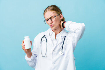 Wall Mural - Young russian doctor woman holding pills bottle on blue suffering neck pain due to sedentary lifestyle.