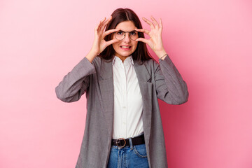 Wall Mural - Young caucasian business woman isolated on pink background keeping eyes opened to find a success opportunity.