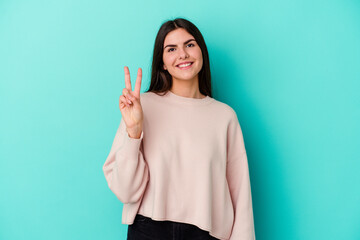 Young caucasian woman isolated on blue background showing number two with fingers.