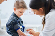 © Kalim - Little boy having blood sample drawn in a lab