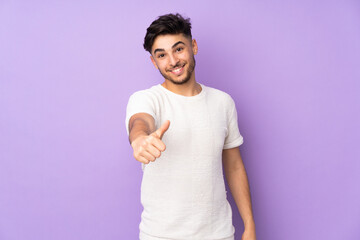 Wall Mural - Arabian handsome man over isolated background with thumbs up because something good has happened