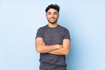 Arabian handsome man over isolated background with arms crossed and looking forward