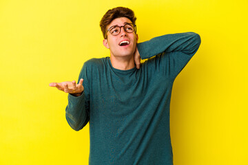 Wall Mural - Young caucasian man isolated on yellow background screaming with rage.