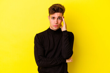 Wall Mural - Young caucasian man isolated on yellow background blows cheeks, has tired expression. Facial expression concept.