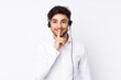 © luismolinero - Telemarketer Arabian man working with a headset isolated on white background doing silence gesture