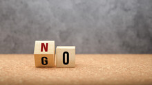 No Versus Go Concept With Words On Wooden Cubes With The First Letter Revolving In A Concept Of Options, Choices And Change On A Cork Base With Copyspace