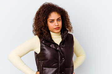 Wall Mural - Young african american woman isolated on white background frowning face in displeasure, keeps arms folded.