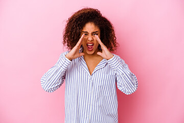 Wall Mural - Young african american woman isolated on pink background shouting excited to front.