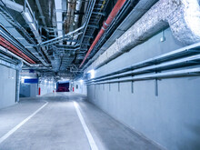 Engineering Premises Of  Stadium. Auxiliary Corridors For Passage Of Special Equipment. Place For Passage Of Special Equipment Inside Stadium. Spacious Corridors Of Stadium With Pipes Under Ceiling