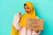 © Asier - Young muslim woman holding a protect our planet isolated on blue background feels proud and self confident, example to follow.
