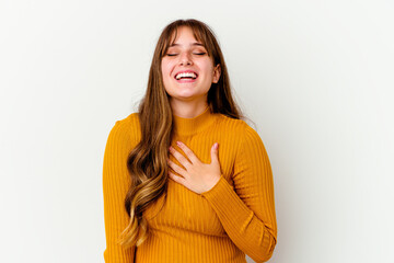 Wall Mural - Young caucasian cute woman isolated on white background laughs out loudly keeping hand on chest.