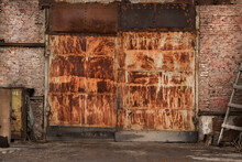 Rusty Big Gates Of An Industrial Abandoned Garage, Brick Walls