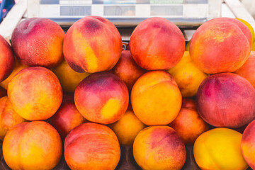 Wall Mural - Heap of juicy fresh nectarine on market background