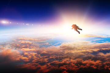 Wall Mural - astronaut in space on planet orbit.