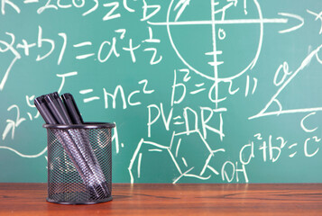 The pen holder in front of the blackboard