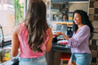 © Brastock Images - lesbian latinx couple together in the kitchen, having a great time